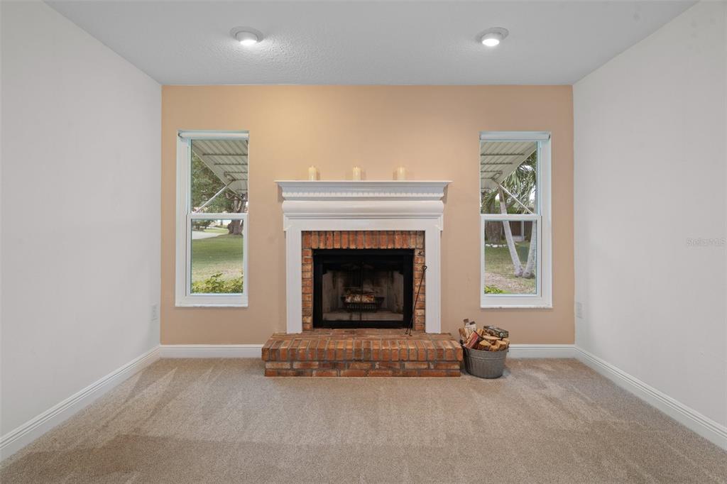 8130 Merrimac Drive Port Richey, FL 34668 - Photo 22 of 53 an empty room with windows and fireplace