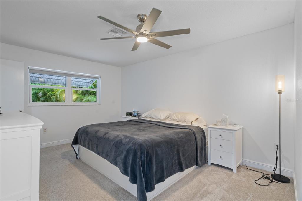 8130 Merrimac Drive Port Richey, FL 34668 - Photo 24 of 53 a bedroom with a bed and a window