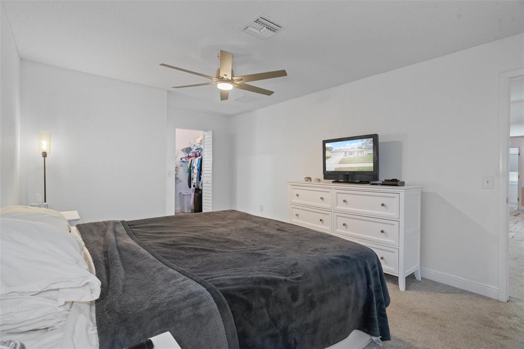 8130 Merrimac Drive Port Richey, FL 34668 - Photo 25 of 53 a bedroom with a bed and a flat screen tv