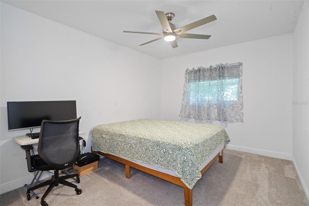 8130 Merrimac Drive Port Richey, FL 34668 - Photo 29 of 53 a room with a bed and chair