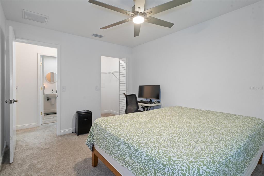 8130 Merrimac Drive Port Richey, FL 34668 - Photo 30 of 53 a bedroom with a bed and a chandelier