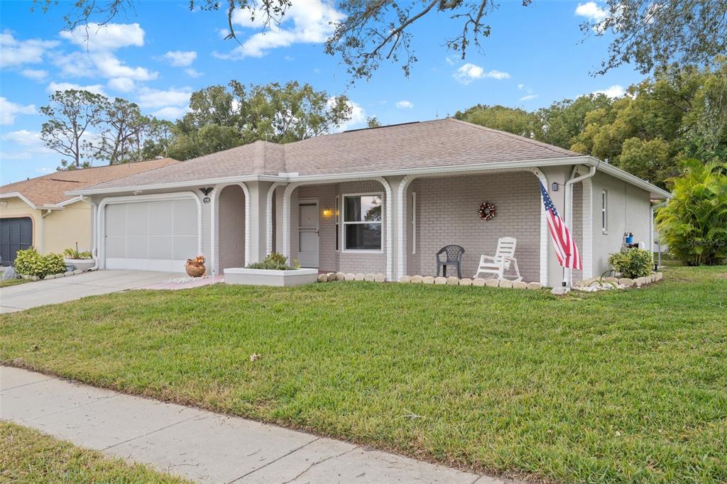 8130 Merrimac Drive Port Richey, FL 34668 - Photo 3 of 53 a backyard of a house with table and chairs