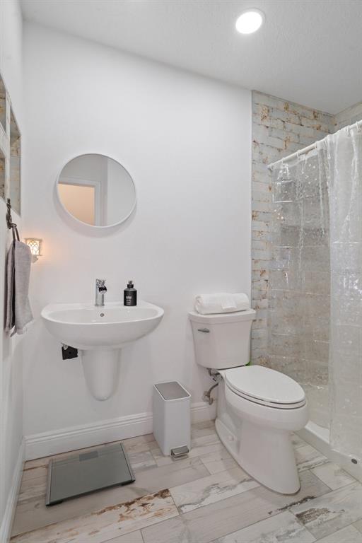 8130 Merrimac Drive Port Richey, FL 34668 - Photo 32 of 53 a bathroom with a toilet and a sink