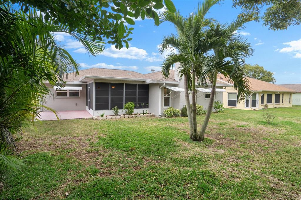8130 Merrimac Drive Port Richey, FL 34668 - Photo 40 of 53 a view of a house with a backyard and a tree