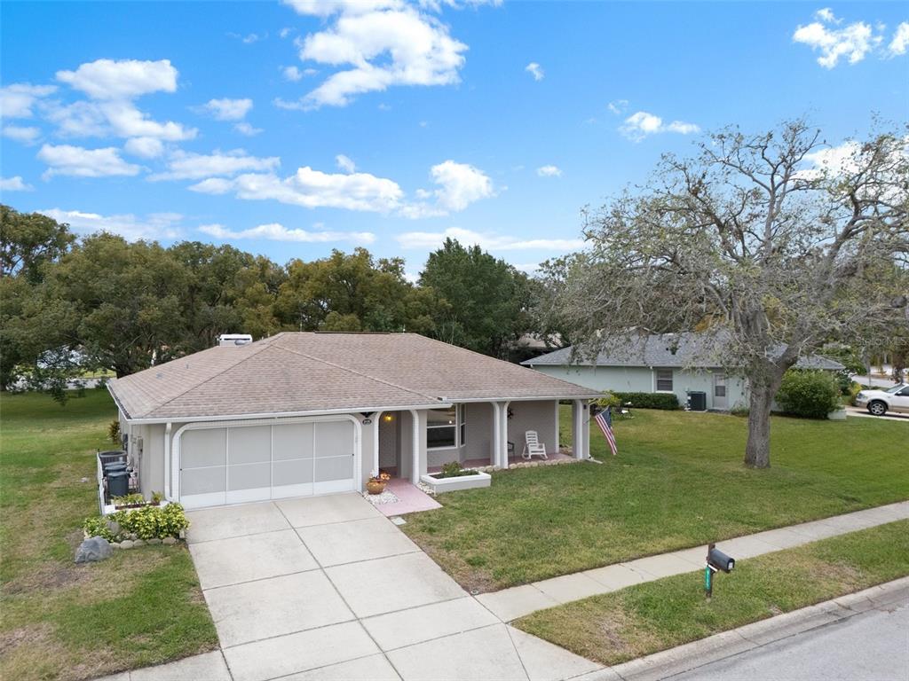 8130 Merrimac Drive Port Richey, FL 34668 - Photo 45 of 53 a front view of a house with garden