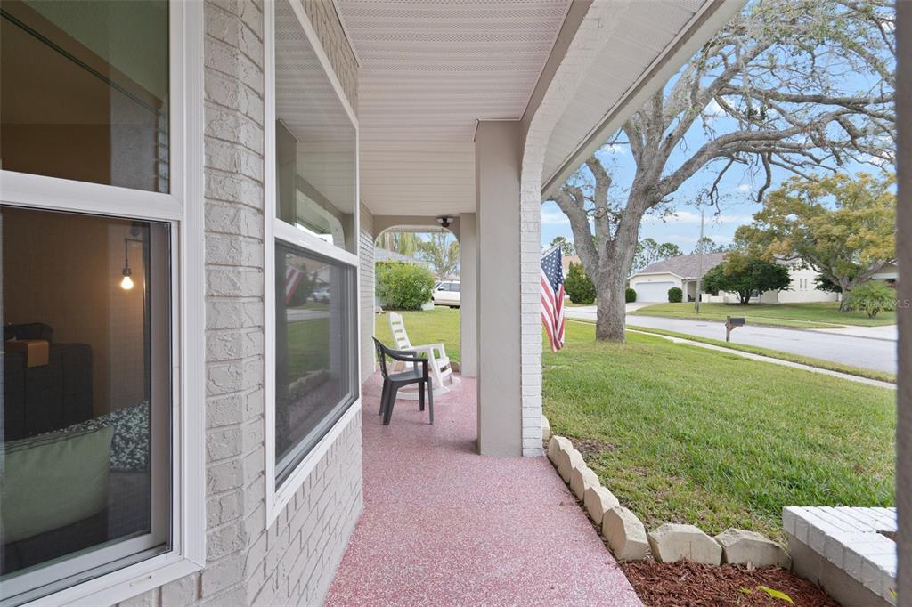 8130 Merrimac Drive Port Richey, FL 34668 - Photo 5 of 53 a view of a porch with chairs and backyard
