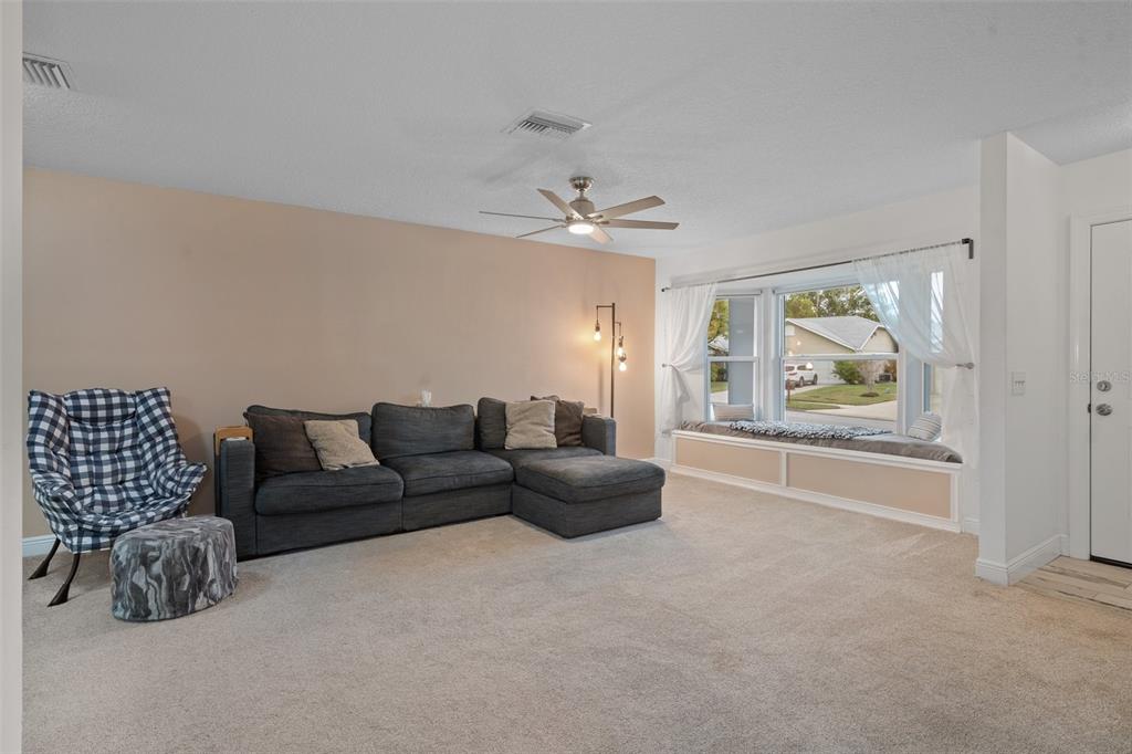 8130 Merrimac Drive Port Richey, FL 34668 - Photo 8 of 53 a living room with furniture and a large window