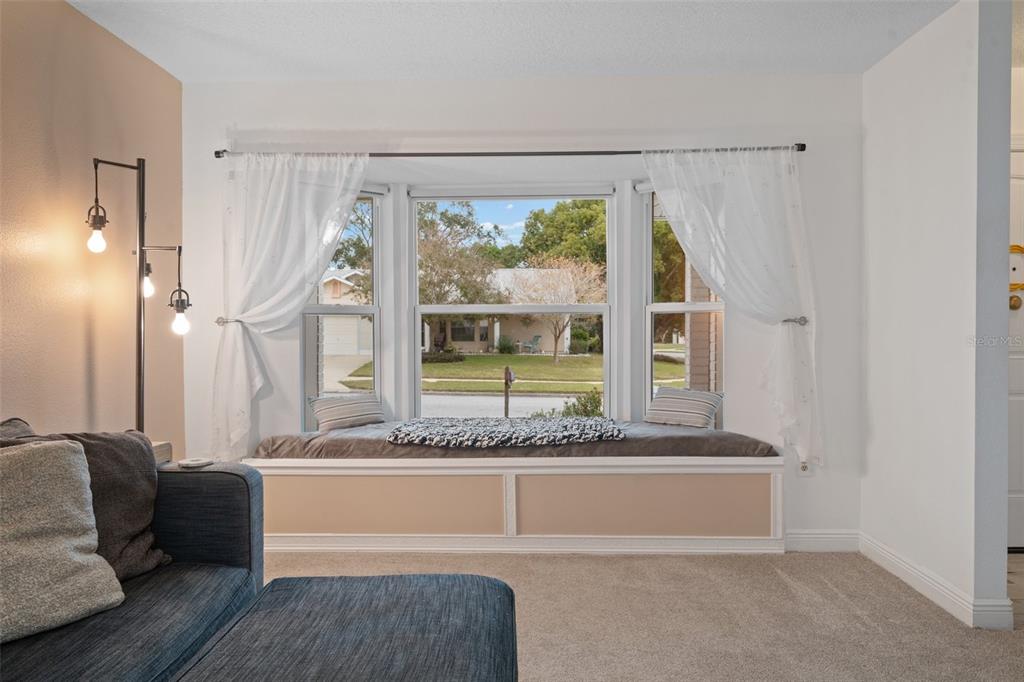 8130 Merrimac Drive Port Richey, FL 34668 - Photo 10 of 53 a living room with a couch and a table