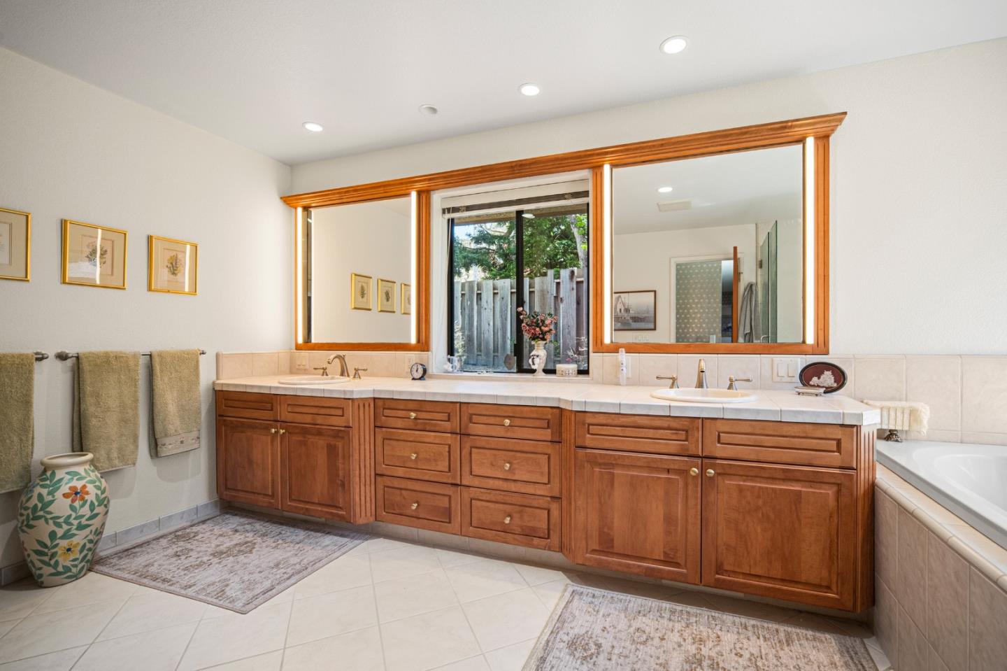 2911 Colton Road Pebble Beach, CA 93953 - Photo 28 of 46 a spacious bathroom with a double vanity sink large mirror and a bathtub