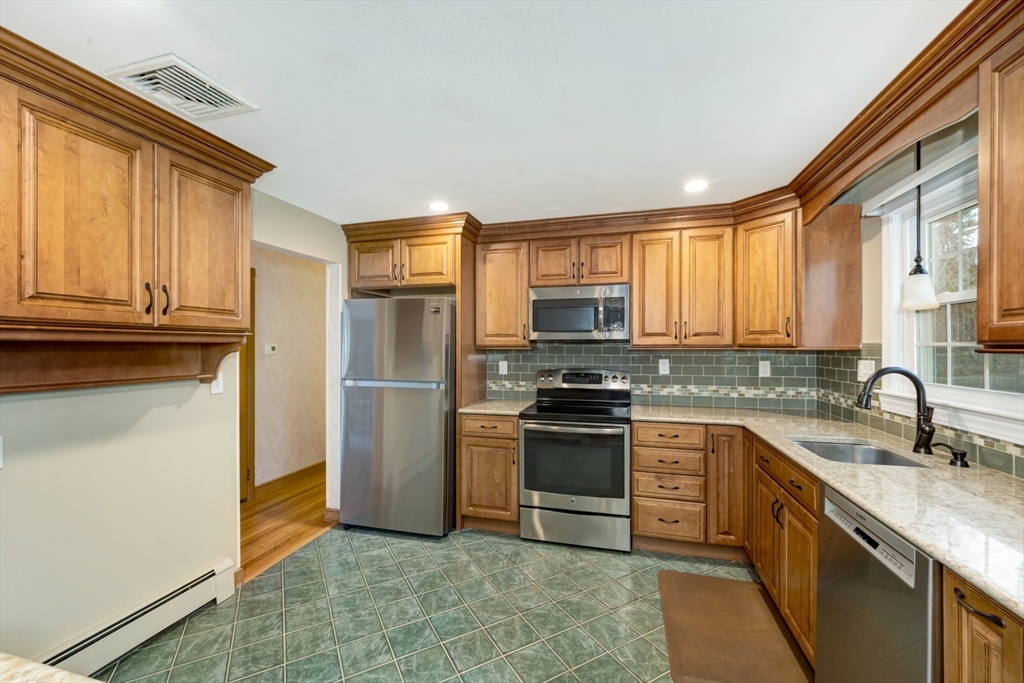 74 Ryder Road Weymouth, MA 02190 - Photo 13 of 33 a kitchen with stainless steel appliances granite countertop a stove a sink and a refrigerator