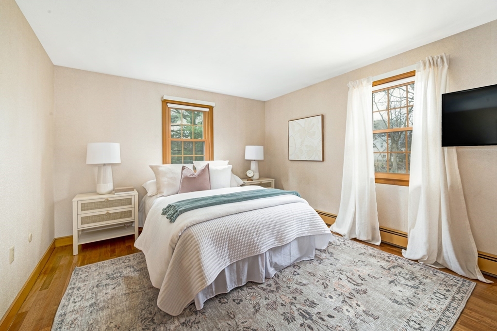 74 Ryder Road Weymouth, MA 02190 - Photo 17 of 33 a bed room with a bed a mirror and a flat tv screen on a dresser