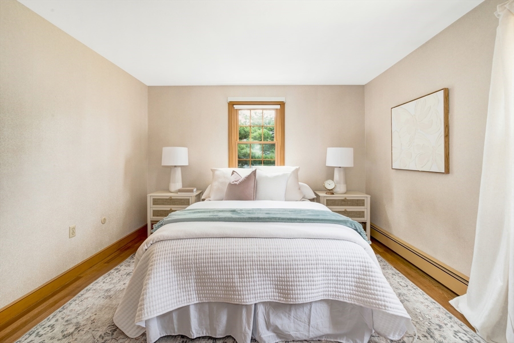 74 Ryder Road Weymouth, MA 02190 - Photo 18 of 33 a bedroom with a bed and wooden floor