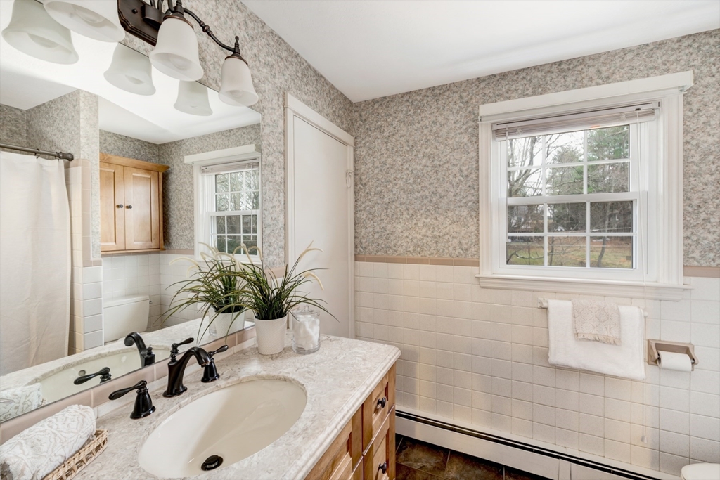 74 Ryder Road Weymouth, MA 02190 - Photo 10 of 33 a bathroom with a sink a vanity and a mirror