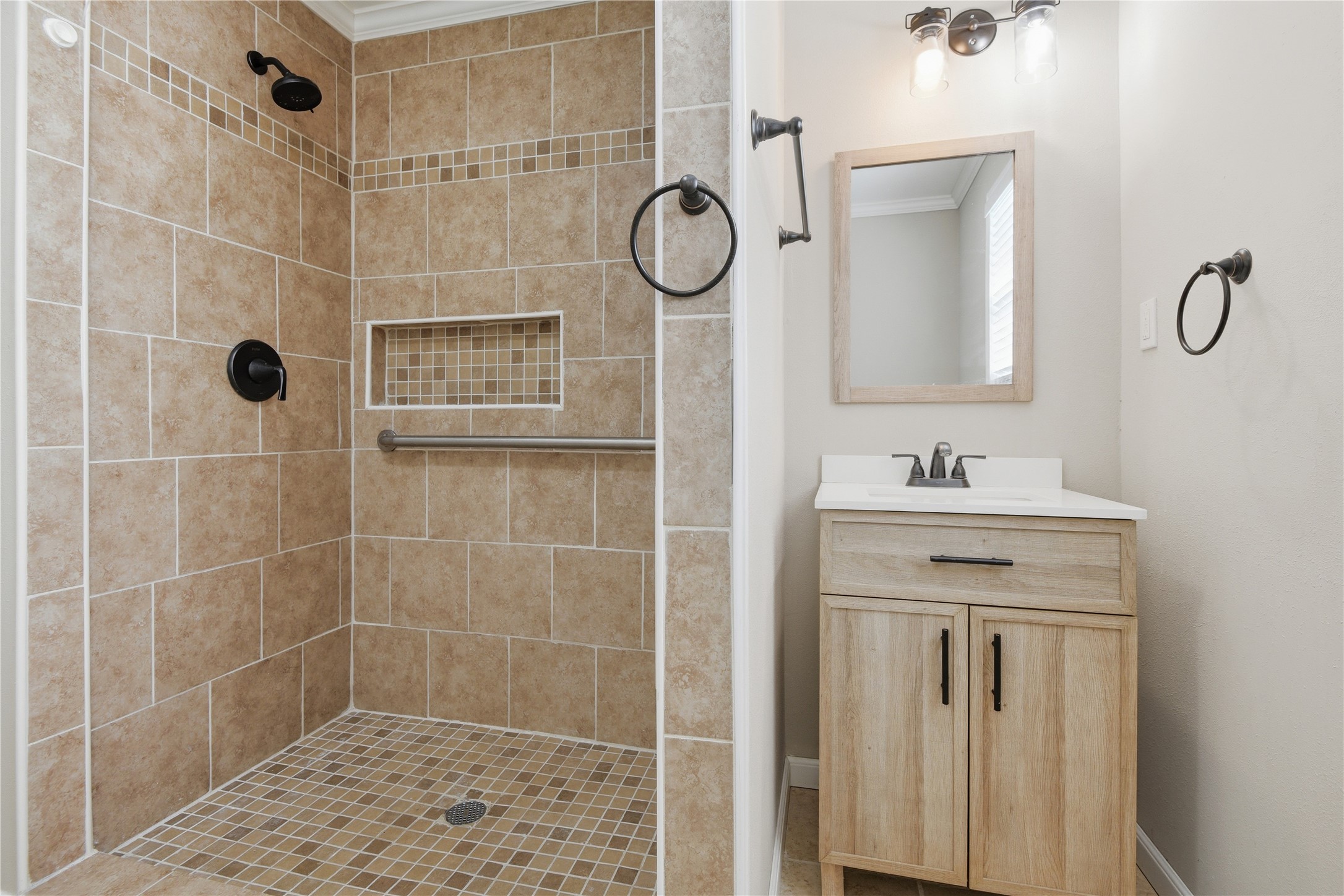 1007 Manatee Lane Houston, TX 77090 - Photo 19 of 25 a bathroom with a shower sink and mirror