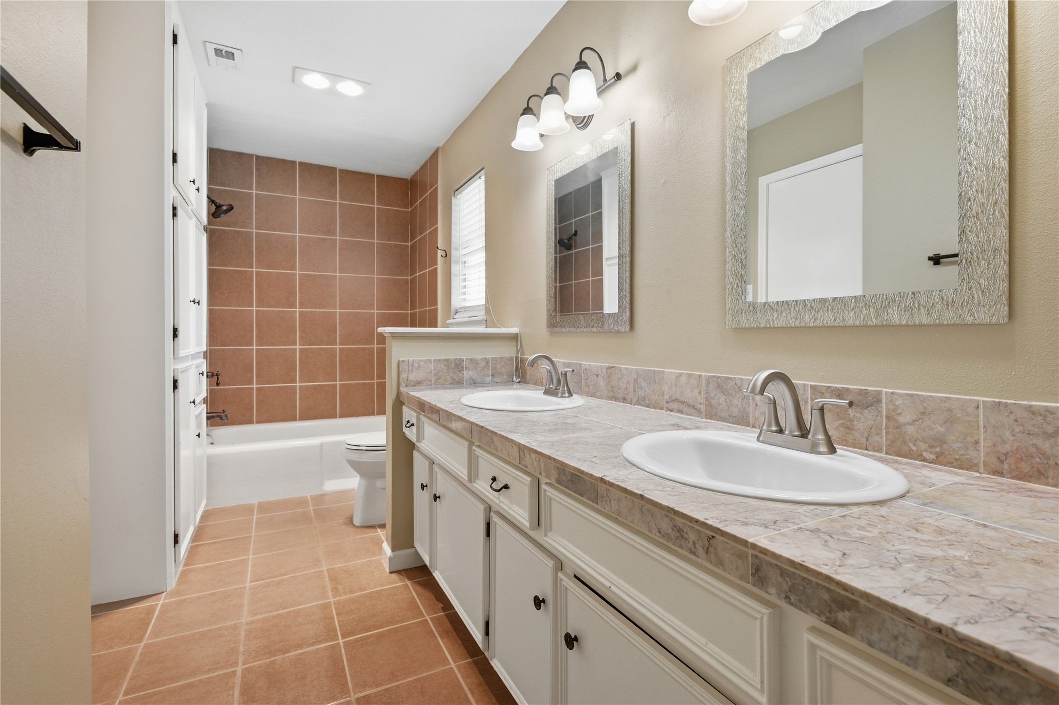 1007 Manatee Lane Houston, TX 77090 - Photo 20 of 25 a bathroom with a granite countertop sink mirror and a bathtub
