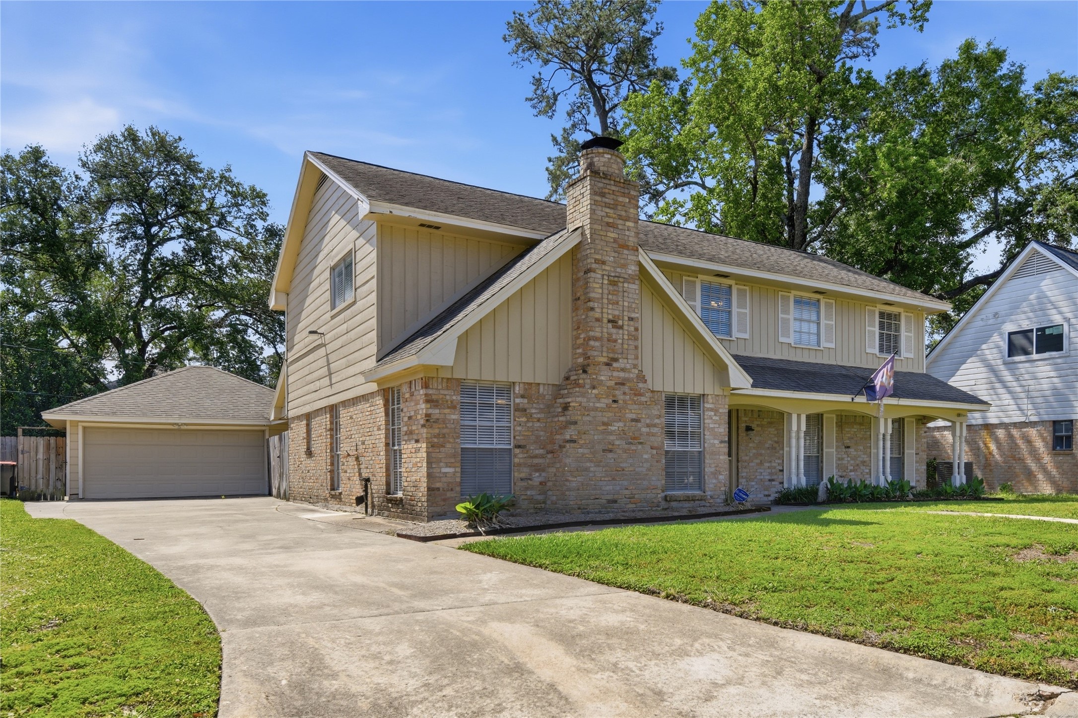 1007 Manatee Lane Houston, TX 77090 - Photo 2 of 25 a view of a house with a yard and large tree
