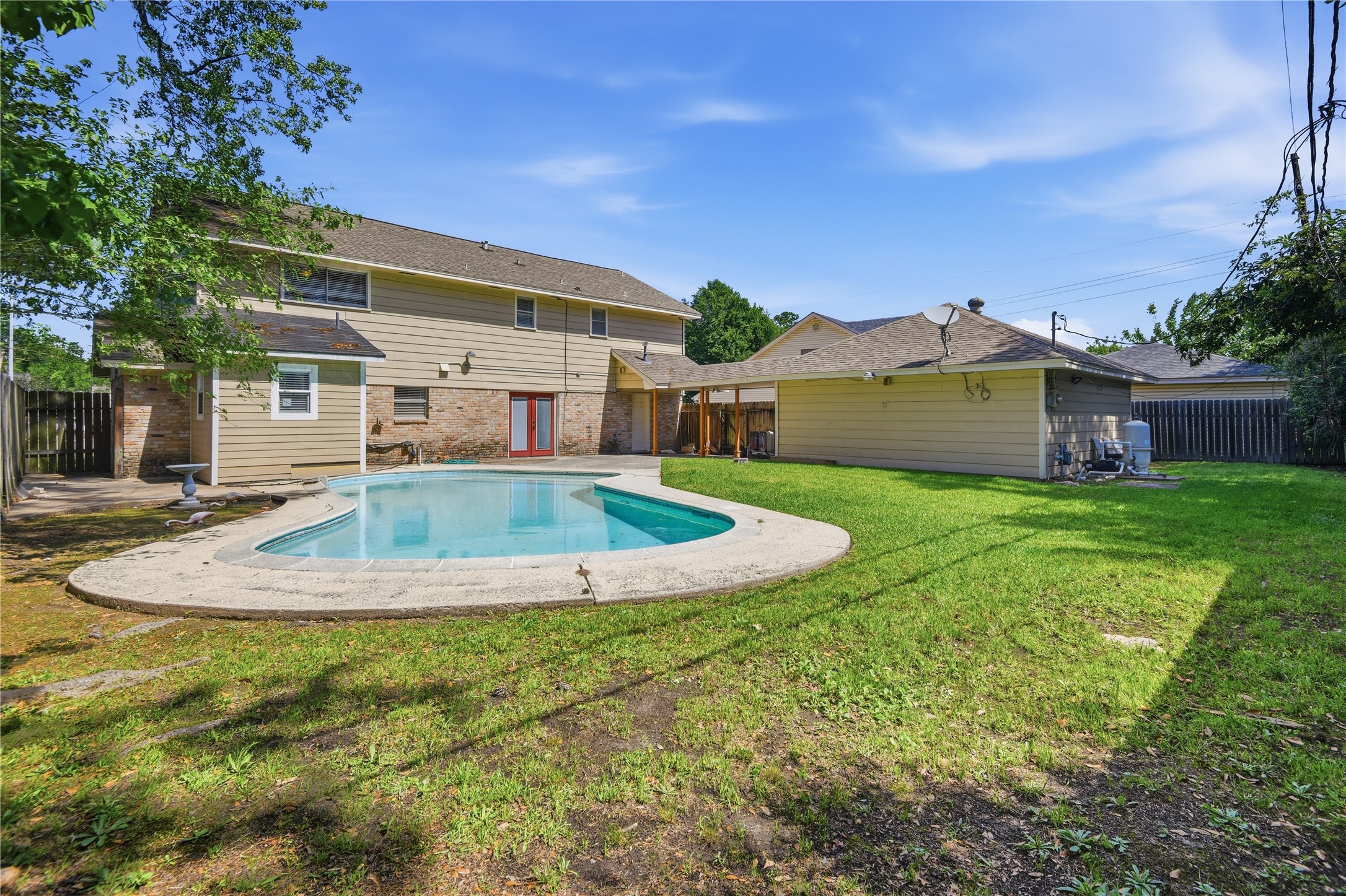 1007 Manatee Lane Houston, TX 77090 - Photo 25 of 25 a view of a house with a swimming pool and a yard