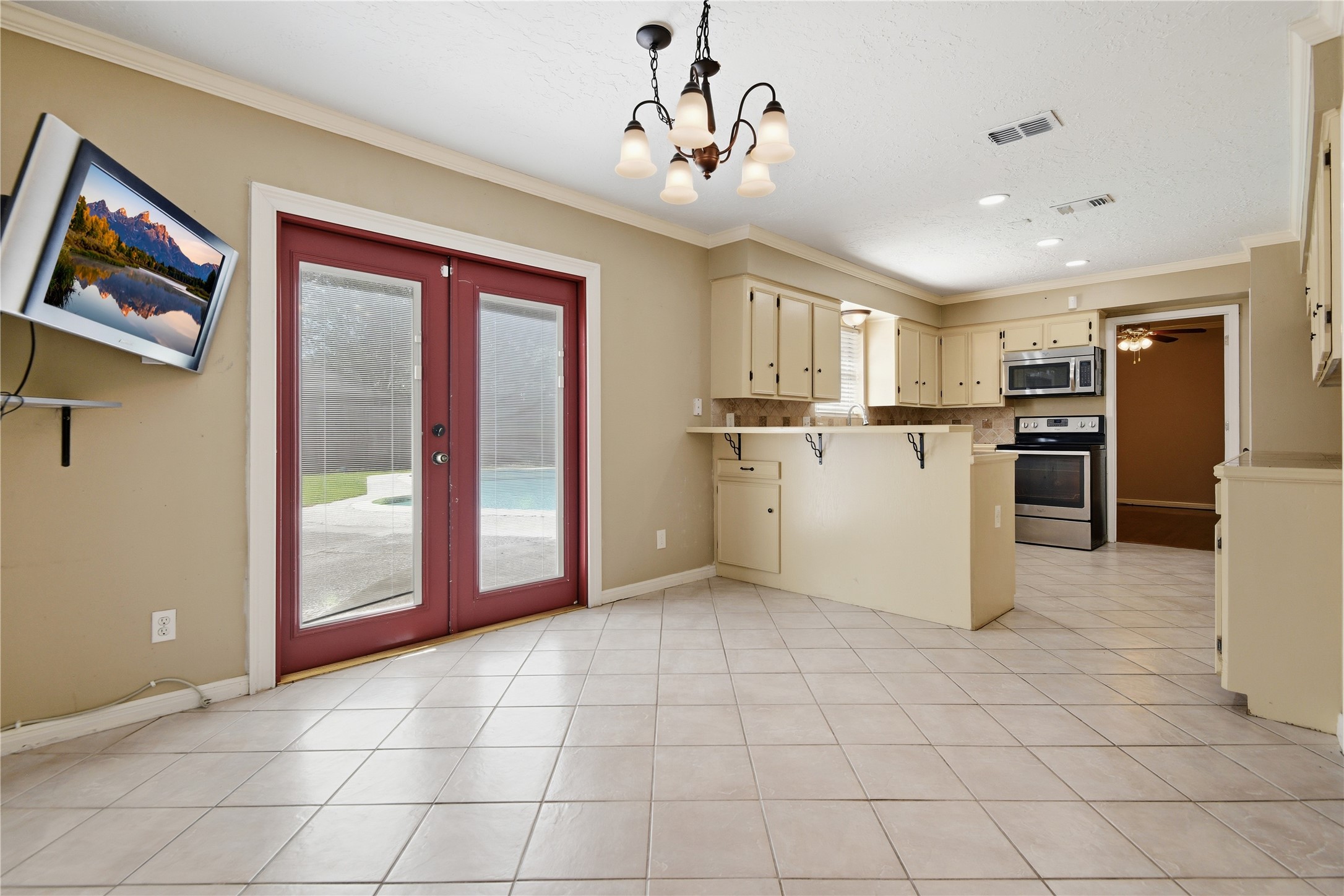 1007 Manatee Lane Houston, TX 77090 - Photo 8 of 25 a view of a kitchen with microwave and refrigerator