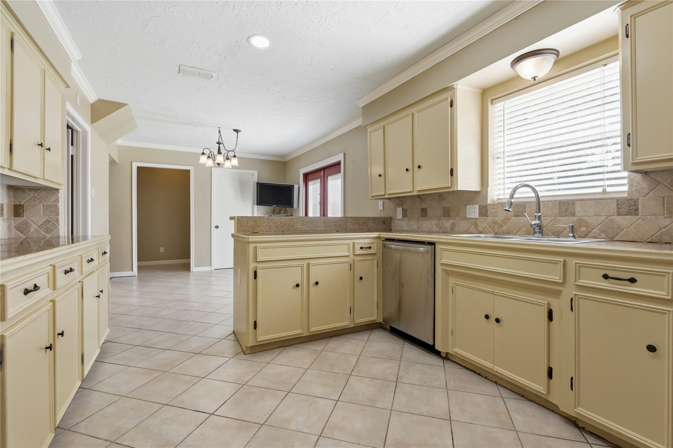 1007 Manatee Lane Houston, TX 77090 - Photo 10 of 25 a kitchen with cabinets appliances and a window