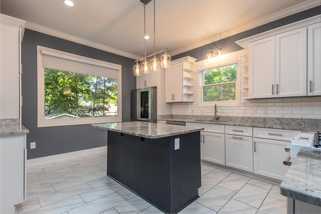 119 South Fenwick Road Memphis, TN 38111 - Photo 2 of 28 a kitchen with kitchen island granite countertop a sink window and cabinets