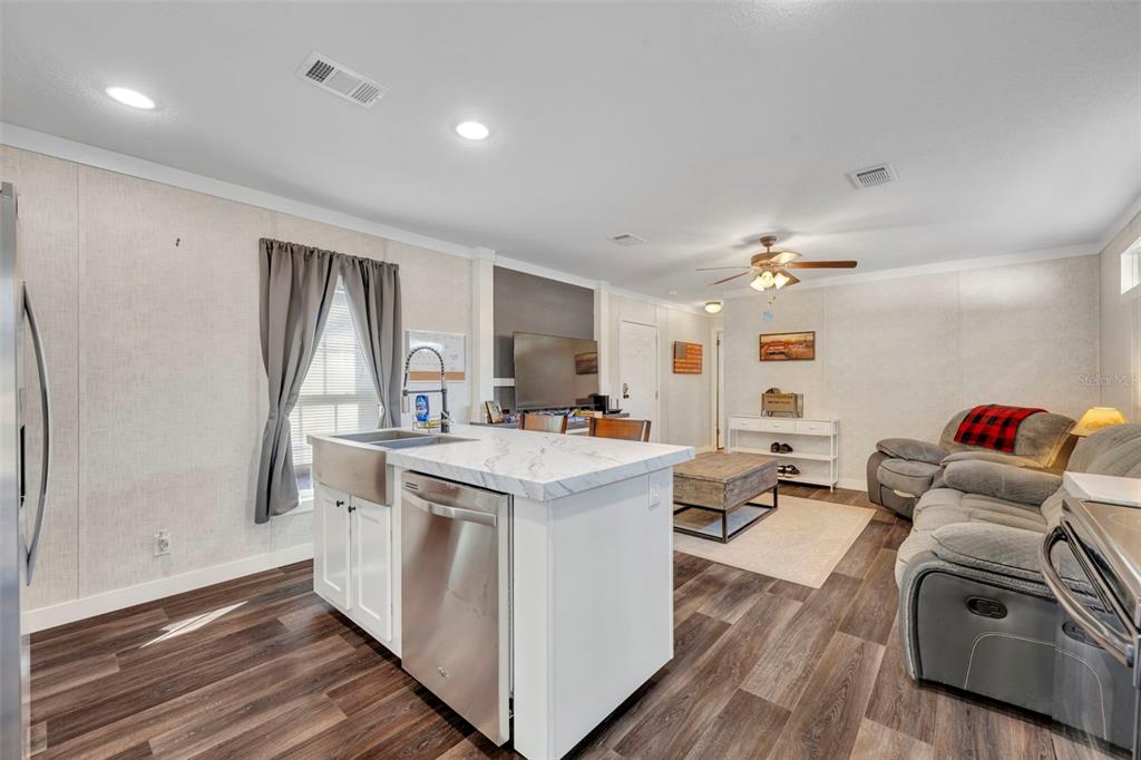 1326 Southwest 69th Road Bushnell, FL 33513 - Photo 11 of 30 a view of living room kitchen with furniture and wooden floor