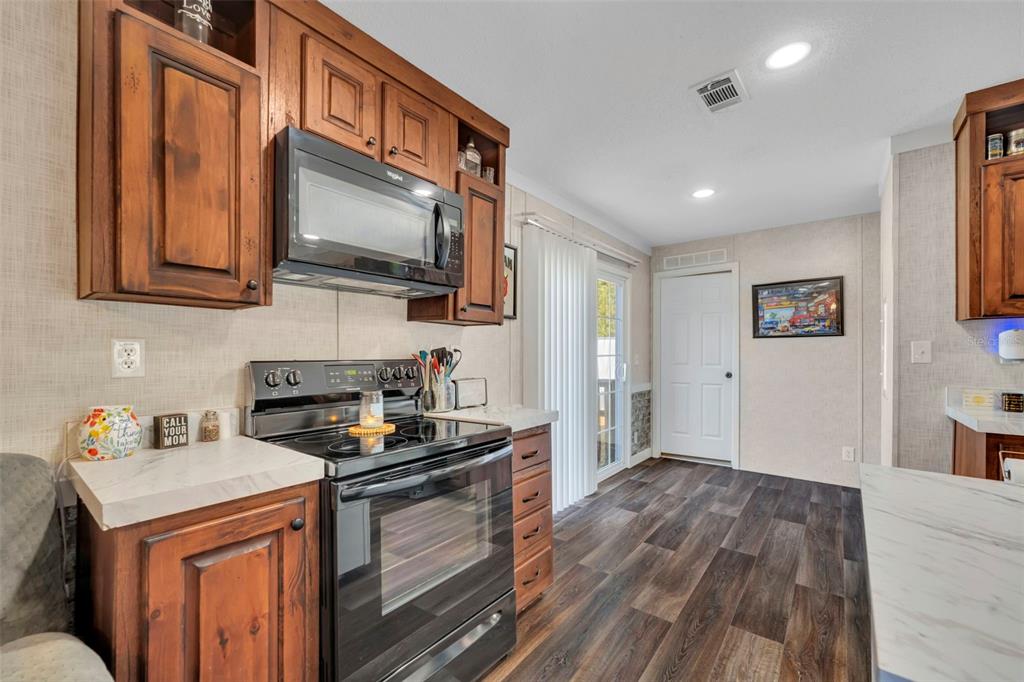 1326 Southwest 69th Road Bushnell, FL 33513 - Photo 12 of 30 a kitchen with a stove and a microwave