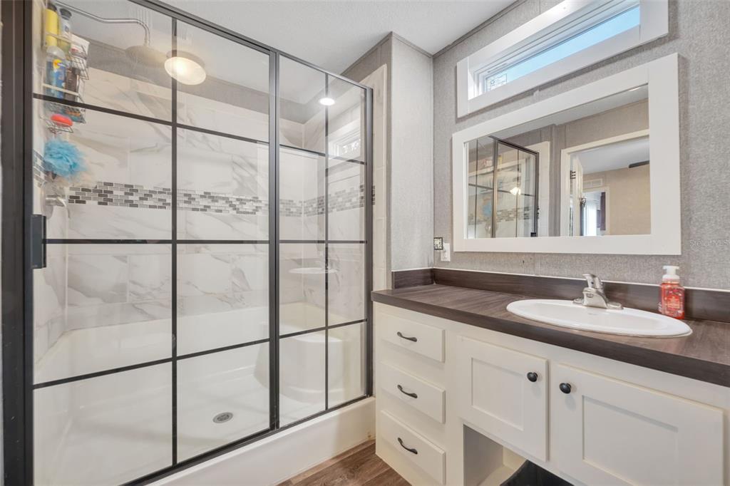 1326 Southwest 69th Road Bushnell, FL 33513 - Photo 17 of 30 a bathroom with a shower sink and mirror