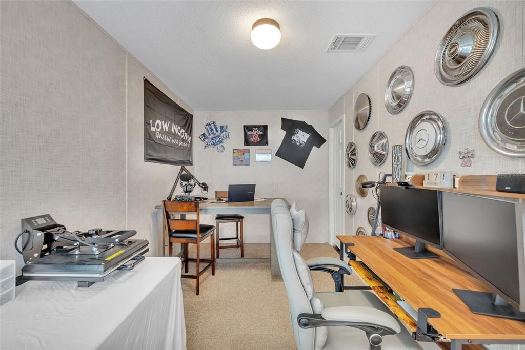 1326 Southwest 69th Road Bushnell, FL 33513 - Photo 21 of 30 a view of a workspace with furniture and a chair