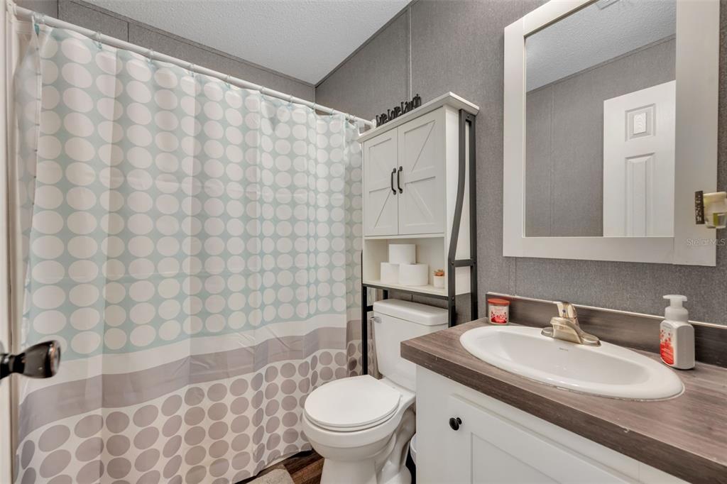 1326 Southwest 69th Road Bushnell, FL 33513 - Photo 22 of 30 a bathroom with a sink toilet and shower