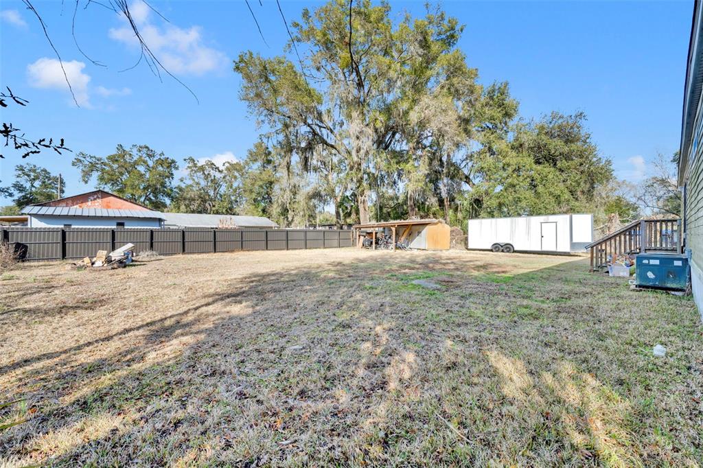 1326 Southwest 69th Road Bushnell, FL 33513 - Photo 29 of 30 a backyard of a house with table and chairs