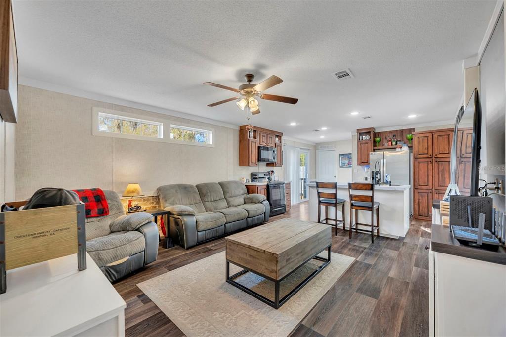 1326 Southwest 69th Road Bushnell, FL 33513 - Photo 4 of 30 a living room with furniture and wooden floor