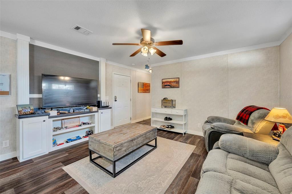 1326 Southwest 69th Road Bushnell, FL 33513 - Photo 5 of 30 a living room with furniture and a flat screen tv