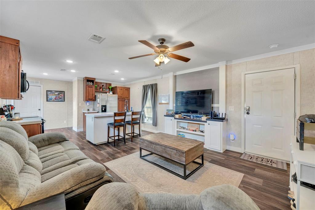 1326 Southwest 69th Road Bushnell, FL 33513 - Photo 7 of 30 a living room with furniture and a flat screen tv
