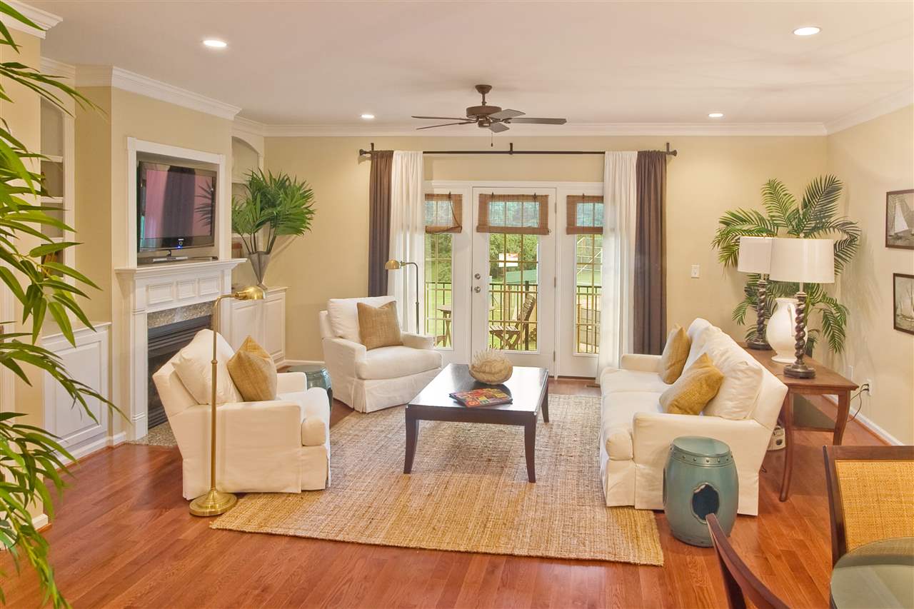 335 Quarry Road, Unit 20 Charlottesville, VA 22902 - Photo 4 of 29 Sophisticated flair in this very open and spacious family room. Direct views to the beautiful covered porch. Custom built in cabinetry flank the gas fireplace. Hardwood flooring & freshly painted.(Photo when furnished. Currently vacant)