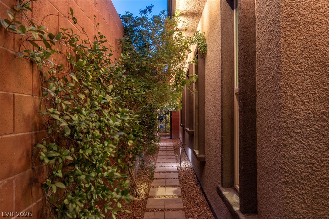 10167 Copper Edge Road Las Vegas, NV 89148 - Photo 44 of 45 A charming garden pathway leads to a private backyard retreat.