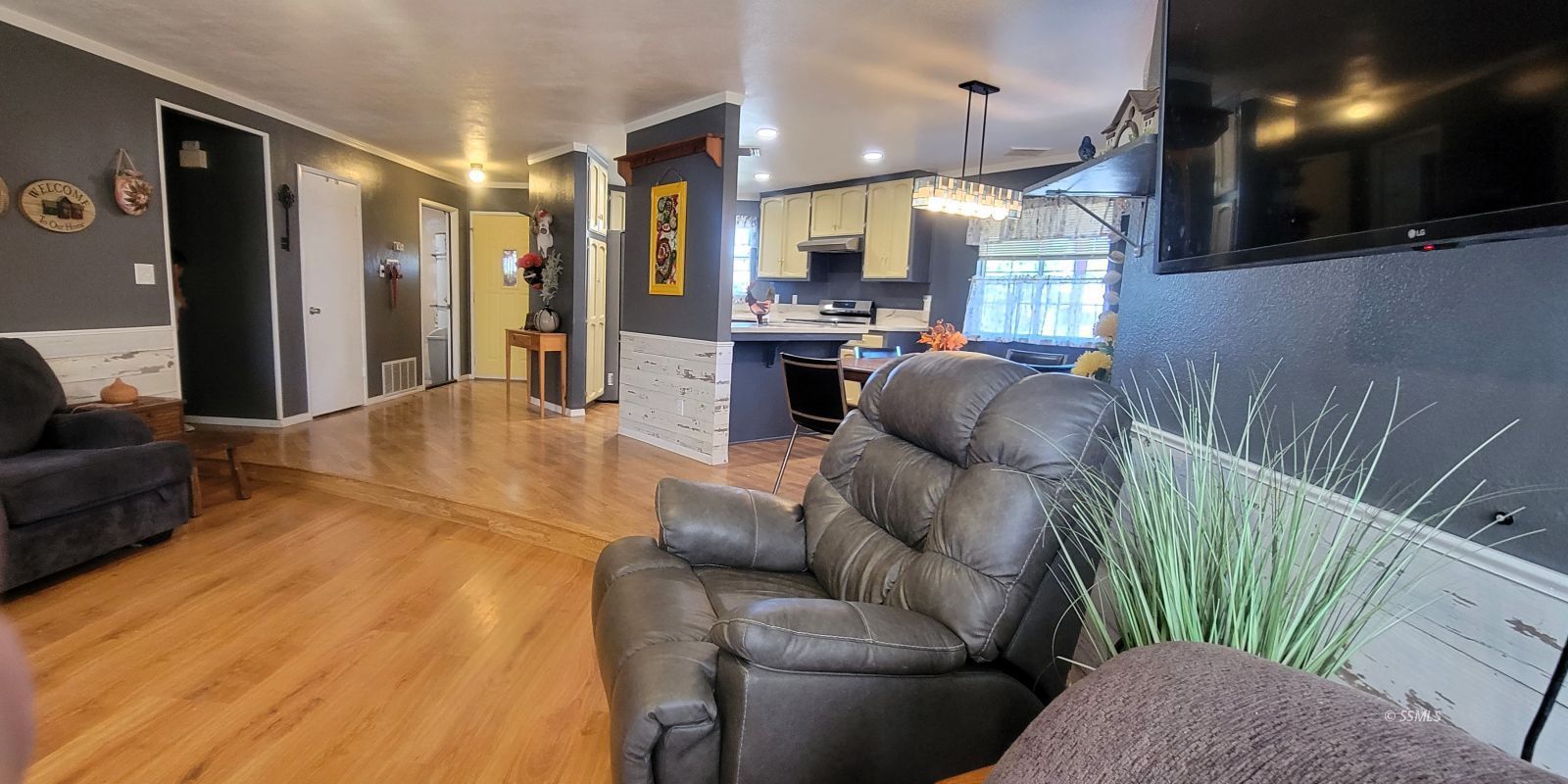 725 Ginger Avenue Ridgecrest, CA 93555 - Photo 5 of 29 a living room with furniture and a chandelier