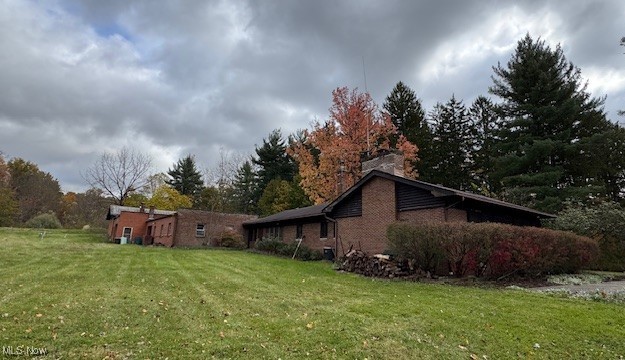 19345 Ridge Road North Royalton, OH 44133 - Photo 42 of 47 View of home's exterior with a lawn, a chimney, and view of wooded area
