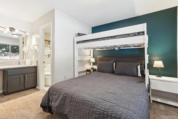 a bedroom with a bed and a sink