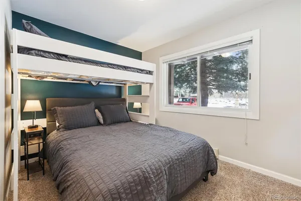 a bed sitting in a bedroom next to a window