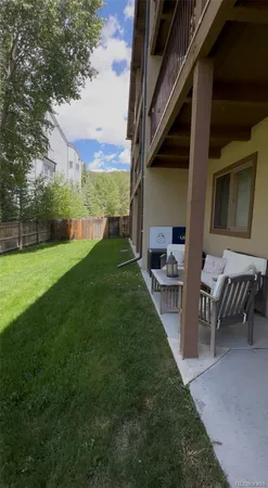a view of a backyard with table and chairs and potted plants