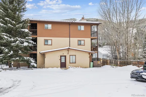 a view of a house with a snow in the yard