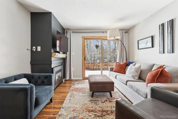 a living room with furniture and a rug