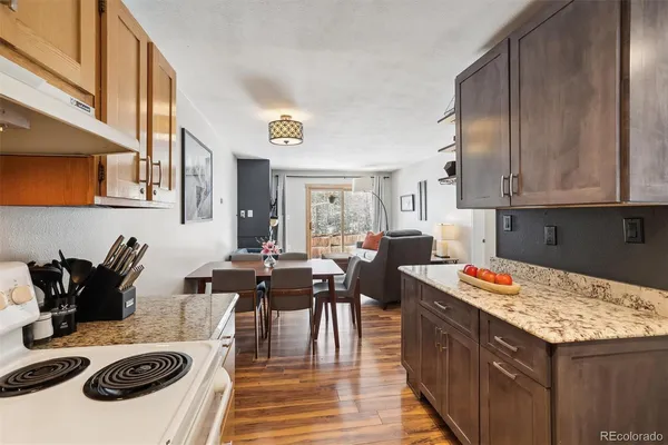 a kitchen with a stove and white cabinets