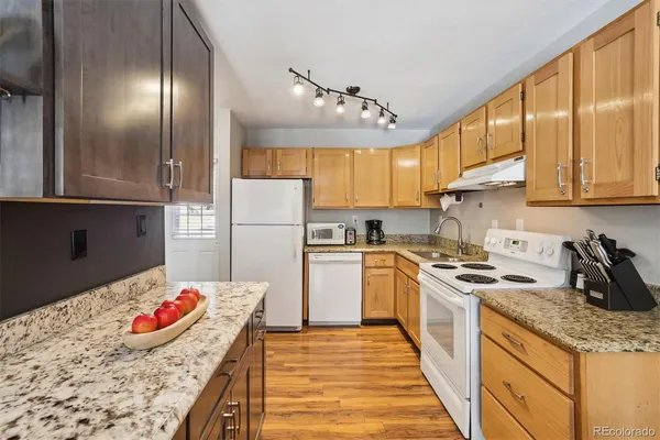 a kitchen with granite countertop stainless steel appliances and wooden cabinets