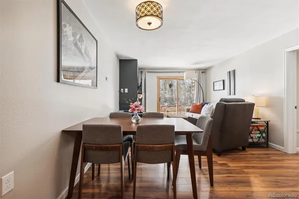 a view of a dining room with furniture and a window