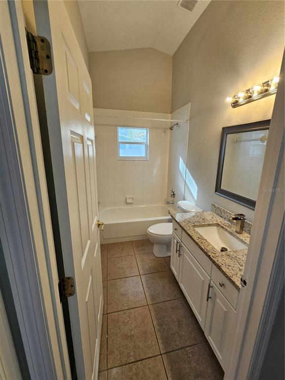 4182 Bedford Road Sanford, FL 32773 - Photo 11 of 18 a bathroom with a granite countertop sink toilet and shower