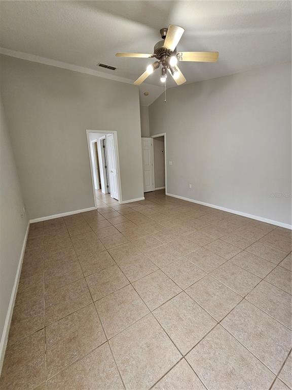 4182 Bedford Road Sanford, FL 32773 - Photo 13 of 18 an empty room with windows and fan