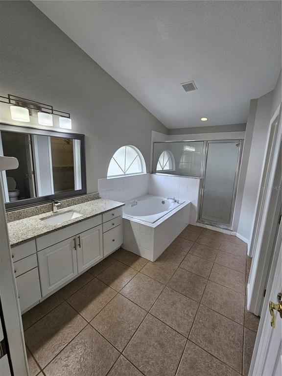 4182 Bedford Road Sanford, FL 32773 - Photo 14 of 18 a large bathroom with a double vanity sink and mirror