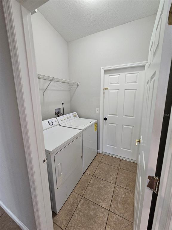 4182 Bedford Road Sanford, FL 32773 - Photo 16 of 18 a utility room with dryer and washer