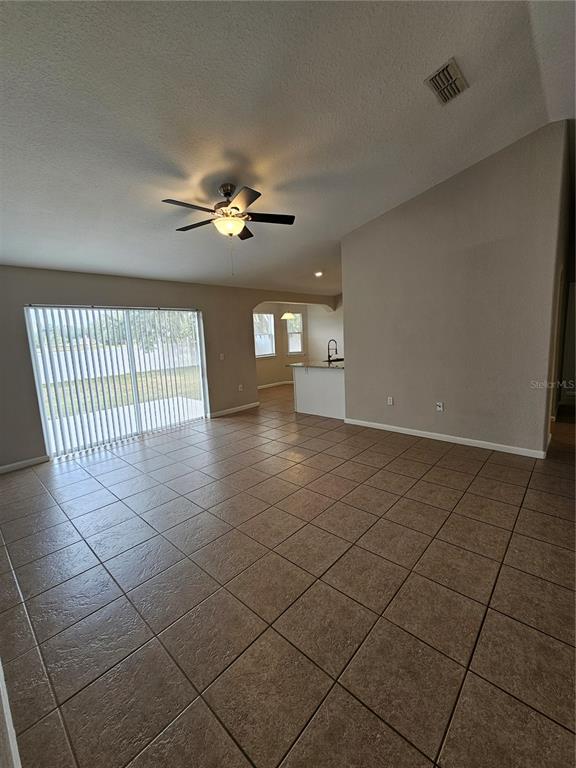 4182 Bedford Road Sanford, FL 32773 - Photo 5 of 18 a view of a livingroom with a chandelier fan and windows